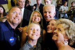 Democratic 2020 U.S. presidential candidate and former Vice President Joe Biden takes photos with supporters at an event at Iowa Wesleyan University in Mount Pleasant, Iowa, June 11, 2019.