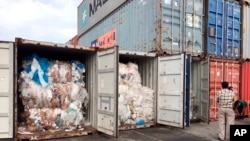 In this Tuesday, July 16, 2019, photo, containers loaded with plastic waste are placed at country beach city, Sihanoukville Port, southwest of Phnom Penh, Cambodia. A Cambodia's committee to investigate the sources of the trash discovered packing in…