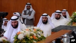 FILE - Abdullah al-Barghash, second from left, returns to parliamentary session after walking out in protest of two female cabinet members that were not dressed according to strict Islamic codes, Kuwait, June 1, 2008.