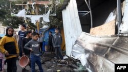 FILE —Children check the damage of a makeshift shelter in a camp set up by displaced Palestinians near the Emirati hospital in Rafah in the southern Gaza Strip, in which several people were reported killed when it was hit by Israeli bombing on March 2, 2024.