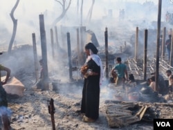 Rohingya refugees at the Cox’s Bazar camp in the aftermath of a devastating fire that killed two people and left thousands homeless, Dec. 24, 2024. (Md. Jamal for VOA)