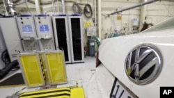 FILE - A 2013 Volkswagen Passat with a diesel engine is evaluated at the California Air Resources Board emissions test lab in El Monte, Calif. 