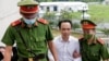Chairman of FLC group Trinh Van Quyet is escorted by police to a court for his trial on fraud charges in Hanoi, Vietnam, on July 22, 2024.