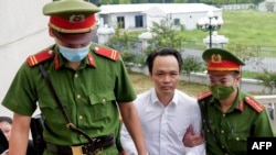 Chairman of FLC group Trinh Van Quyet is escorted by police to a court for his trial on fraud charges in Hanoi, Vietnam, on July 22, 2024.