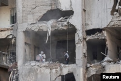 People search for their belongings inside a damaged building in the aftermath of an Israeli strike in Beirut's Basta neighborhood on Nov. 23, 2024.