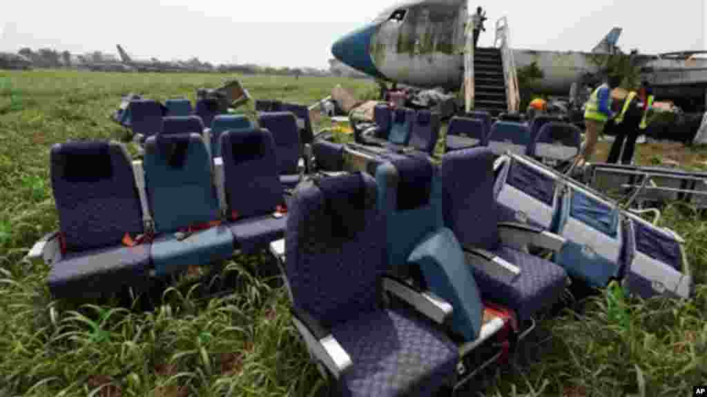 Seats removed from the fuselage of an abandoned aircraft are piled up at Murtala Muhammed International Airport in Lagos, Nigeria.