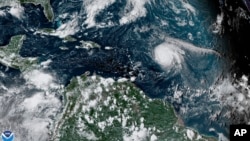 This satellite image shows Hurricane Sam, center right, in the Atlantic Ocean, Monday, Sept. 27, 2021. National Oceanic and Atmospheric Administration's Atlantic hurricane season forecast calls for 14 to 21 named storms, with six to 10 becoming hurricanes.