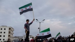 People gather to celebrate the fall of the Syrian government, in Manbij, Syria, Dec. 8, 2024.