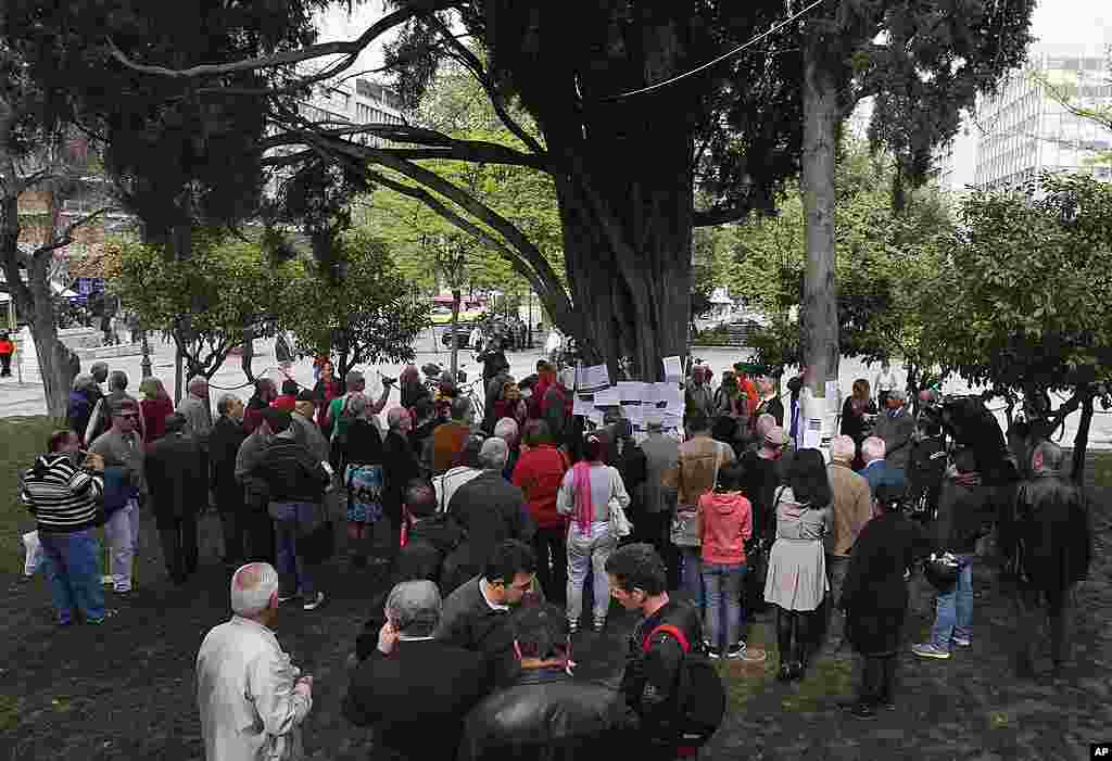 People gather at the site where an elderly man fatally shot himself at Athens' Syntagma square. (AP)