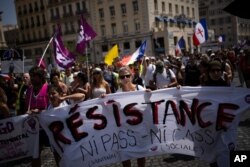 Protesters march during a demonstration in Marseille, southern France, Aug. 14, 2021, to denounce a COVID-19 health pass needed to access restaurant, long-distance trains and other venues.