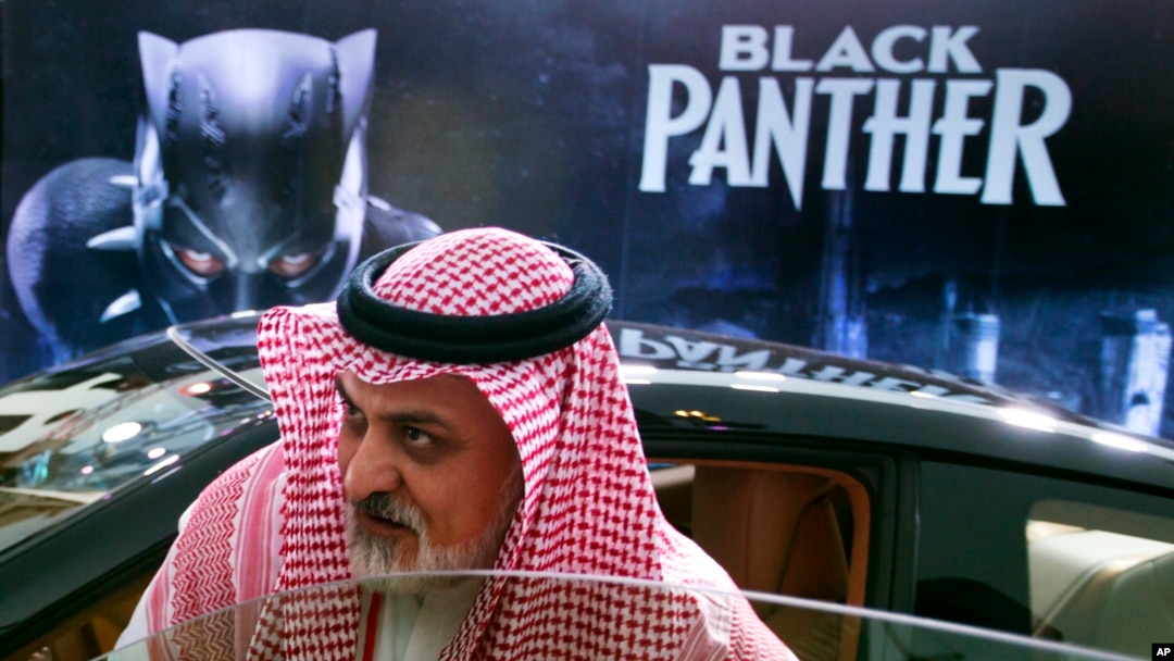 A visitor checks out a Lexus, similar to one used in the "Black Panther" film, that is on display outside an invitation-only screening, at the King Abdullah Financial District Theater, in Riyadh, Saudi Arabia, April 18, 2018. Saudi Arabia held a private screening of the Hollywood blockbuster "Black Panther" Wednesday, to herald the launch of movie theaters that are set to open to the public next month. 