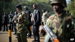 Kenyan security forces line up behind Interior Minister Joseph Ole Lenku during press conference near Westgate Mall, Nairobi, Sept. 25, 2013.