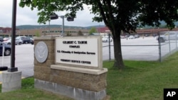 FILE - A sign marks the location of the U.S. Citizenship and Immigration Services Vermont Service Center, July 14, 2020, in St. Albans, Vermont. With some exceptions, USCIS will operate as usual if the government shuts down, because it is mostly fee-funded.
