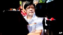 Vice presidential candidate Sen. Ferdinand "Bongbong" Marcos Jr. talks to the media during his campaign sortie in Muntinlupa city, southeast of Manila, Philippines, Feb. 22, 2016.