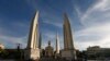 Volunteers from anti-government protesters clean up after an overnight shooting attack at Democracy Monument in Bangkok, Thailand, Thursday, May 15, 2014.