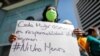 A woman holds a placard as Venezuelan human rights activists protest to demand the release of 17 women they consider political prisoners, as well as to demand punishment for perpetrators of femicide, in Caracas, Venezuela, March 8, 2021.