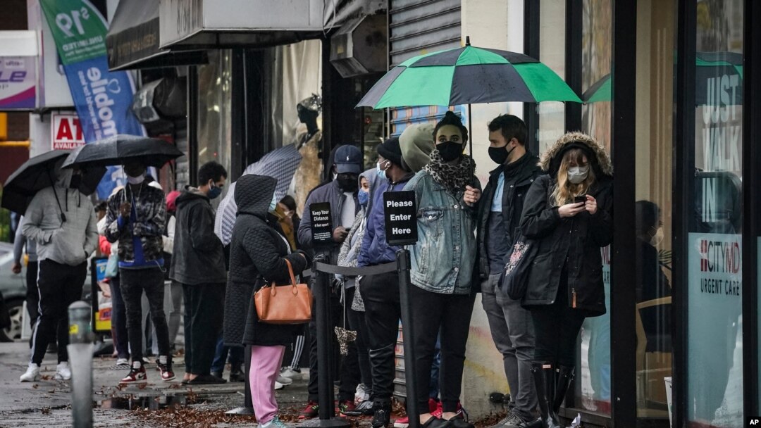 People queue outside an urgent care clinic, a designated COVID-19 testing center, in New York City, in Nov. 13, 2020. 