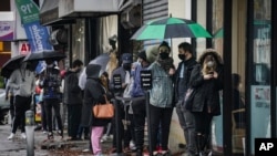 People queue outside an urgent care clinic, a designated COVID-19 testing center, in New York City, in Nov. 13, 2020. 