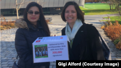 Women’s rights activists Maryam Qashqaei Shojaei and Gigi Alford hold a petition outside FIFA’s Zurich headquarters, Nov. 8, 2018. The petition calls for an end to Iran’s decades-old ban on Iranian women buying stadium tickets for men’s sporting events.