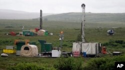 FILE - Workers with the Pebble Mine project test drill in the Bristol Bay region of Alaska near the village of Iliamna, July 13, 2007.