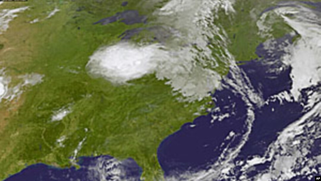 This image provided by NASA taken at 2:32 a.m. EDT Wednesday morning Aug. 3, 2011 shows tropical storm Emily, lower right. Forecasters at the National Hurricane Center in Miami said up to 10 inches (25 centimeters) of rain could fall Wednesday in some par