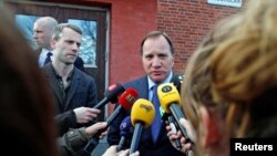 A man removes broken glass scattered on the carpet of a mosque damaged in Tuesday's blast in Beirut, Lebanon.