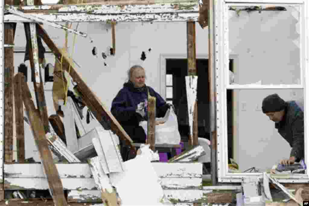 Daniel Ward, right, and his wife Peggy Ward search through a home destroyed by a tornado in Henryville, Ind., Sunday, March 4, 2012.