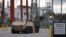 FILE - A pair of armored personnel carriers are parked on the grounds of the General Dynamics Land Systems - Canada factory in London, Ontario, Canada Oct. 23, 2018.