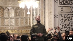 The leader of Syria's Islamist Hayat Tahrir al-Sham (HTS) group that headed a lightning rebel offensive snatching Damascus from government control, Abu Mohammed al-Jolani, addresses a crowd at the capital's landmark Umayyad Mosque on Dec. 8, 2024. 