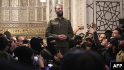 The leader of Syria's Islamist Hayat Tahrir al-Sham (HTS) group that headed a lightning rebel offensive snatching Damascus from government control, Abu Mohammed al-Jolani, addresses a crowd at the capital's landmark Umayyad Mosque on Dec. 8, 2024. 