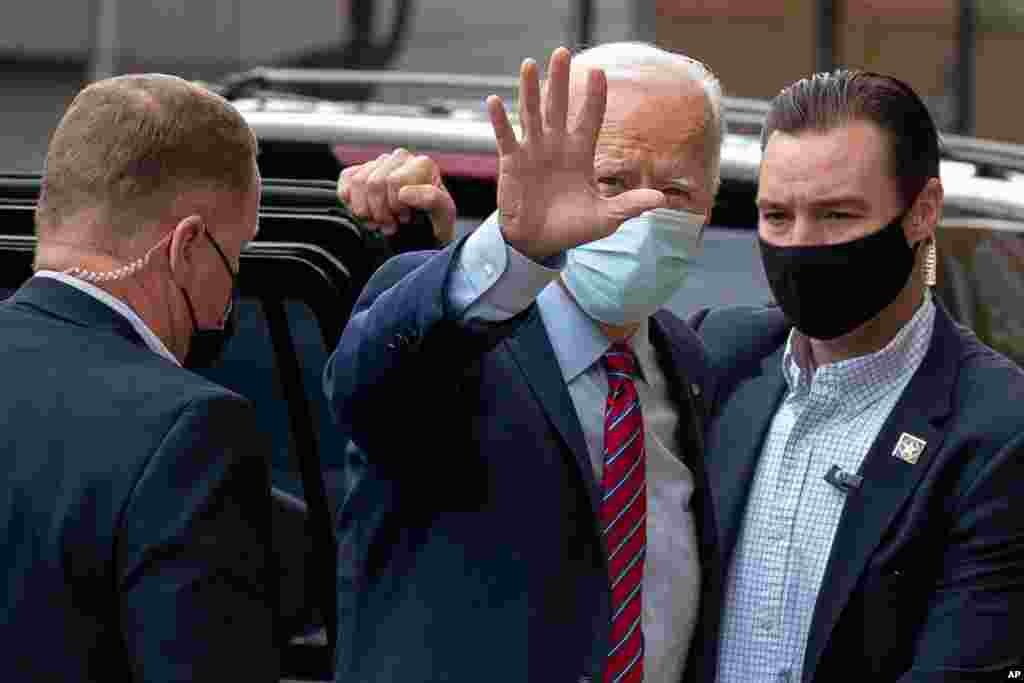Democratic presidential candidate former Vice President Joe Biden waves as he arrives at The Queen theatre in Wilmington, Del., Oct. 19, 2020.