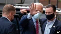 Democratic presidential candidate former Vice President Joe Biden waves as he arrives at The Queen theatre in Wilmington, Del., Oct. 19, 2020.