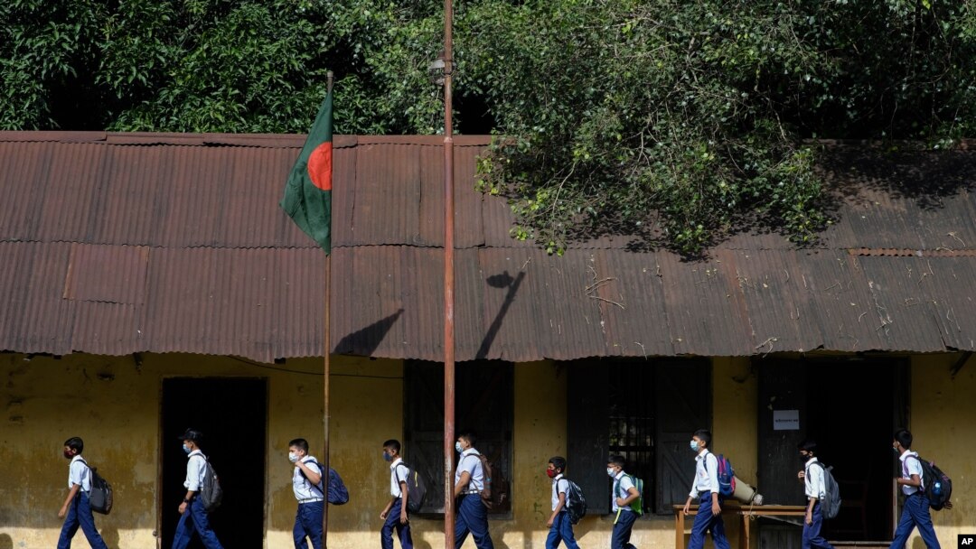 Students arrive at the Narinda Government High School as schools reopen after being closed for nearly 18 months due to the coronavirus pandemic in Dhaka, Bangladesh, Sept.12, 2021.