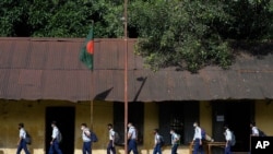 Students arrive at the Narinda Government High School as schools reopen after being closed for nearly 18 months due to the coronavirus pandemic in Dhaka, Bangladesh, Sept.12, 2021.