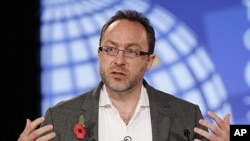 Wikipedia co-founder Jimmy Wales gestures during the opening session at the London Cyberspace Conference, November 1, 2011.