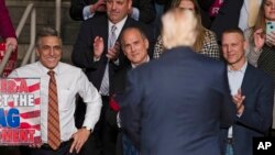 FILE - U.S. Rep. Lou Barletta, left, R-Pa., U.S. Rep. Tom Marino, center left, R-Pa., and U.S. Rep. Scott Perry, right, R-Pa., watch as President-elect Donald Trump, center right, departs a rally in Hershey, Pa, Dec. 15, 2016. 