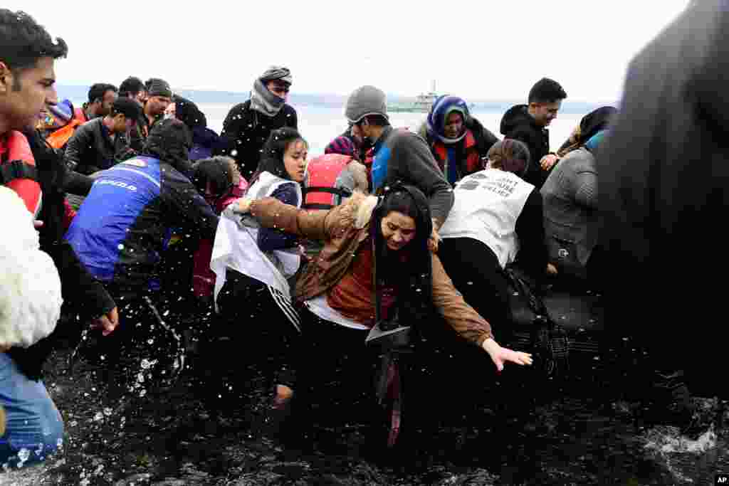 Migrants arrive with a dinghy at the village of Skala Sikaminias, on the Greek island of Lesbos, after crossing the Aegean Sea from Turkey.
