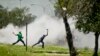 Protesters caught in teargas, hurl stones at police, unseen, during violent clashes in Sasolburg, South Africa, January 22 2013.