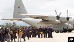 Thai Navy SEALs and military personnel take a group picture before they board a plane at the airport in Chiang Rai, northern Thailand, Thursday, July 12, 2018. 