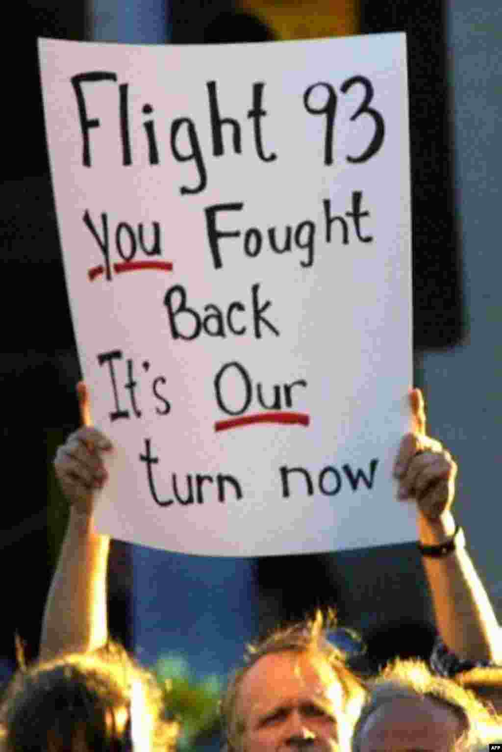 A sign is held up in the crowd before a memorial service for victims of United Airlines Flight 93, in Somerset, Pa. Friday, Sept. 14, 2001. Volunteers led a prayer service Friday as investigators continued to comb through the wreckage of the airliner sea