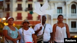 FILE - Activists take part during a demonstration to protest violence against women in Cartagena, Colombia, Oct. 27, 2016. 