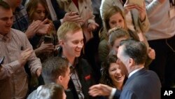 University of Utah students shake hands with former presidential candidate Mitt Romney after he made a speech criticizing Donald Trump Thursday, March 3, 2016, in Salt Lake City. The 2012 GOP presidential nominee has been critical of front-runner Donald Trump on Twitter in recent weeks and has yet to endorse a candidates. (Al Hartmann/The Salt Lake Tribune via AP)