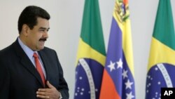 Venezuela's President Nicolas Maduro stands before reporters on the sidelines of a bilateral meeting with Brazil's President Dilma Rousseff in Brasilia, Jan. 2, 2015.