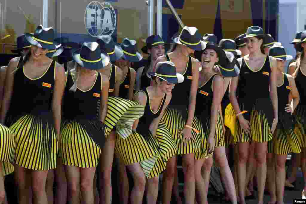 Grid girls are seen at the Hungaroring racing circuit in Budapest prior to the Formula One Hungarian Grand Prix.