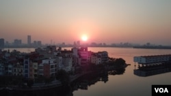 The sun sets in Hanoi, where growing demand for housing puts Vietnam at risk of the affordability issues seen in countries from Japan to Sweden. 