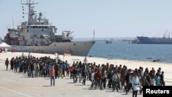 Migrants are disembarked from the Italian navy ship Vega in the Sicilian harbor of Augusta, southern Italy, May 4, 2015.