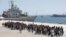 Migrants are disembarked from the Italian navy ship Vega in the Sicilian harbor of Augusta, southern Italy, May 4, 2015.