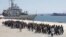 Migrants are disembarked from the Italian navy ship Vega in the Sicilian harbor of Augusta, southern Italy, May 4, 2015.