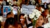 FILE - Relatives of victims of President Rodrigo Duterte's so-called war on drugs hold a memorial for their loved ones, at a church in Manila, Philippines, March 17, 2019. 