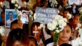FILE - Relatives of victims of then-President Rodrigo Duterte's so-called war on drugs hold a memorial for their loved ones, at a church in Manila, Philippines, March 17, 2019. 